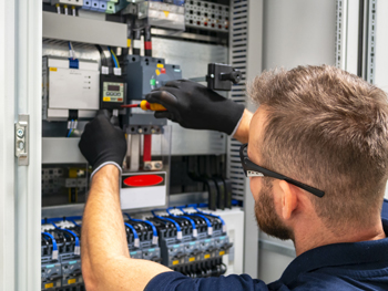 Electrical technician providing maintenance services