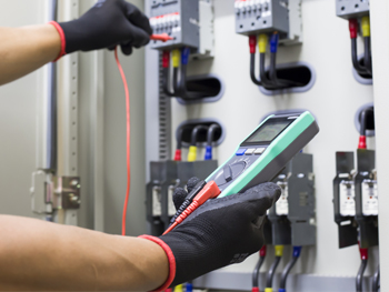 Electrician working on testing an electrical system